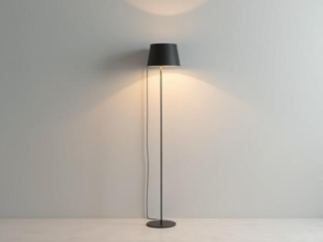 An elegant, simple floor lamp with a matte black finish and warm glow.