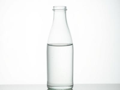 Recycled glass carafe with a unique, textured surface.